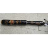 An early 19thC black lacquered wooden truncheon,
