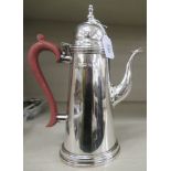 A Georgian style silver coffee pot of tapered form with an S-shaped spout,