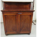 An early Victorian mahogany chiffonier with a pillared upstand, over two panelled doors,