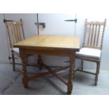 A 1920s oak drawer leaf table, raised on barleytwist and block legs 30''h 35.