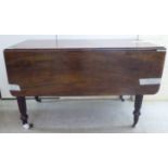 A George III mahogany Pembroke table with an end drawer, raised on tapered,