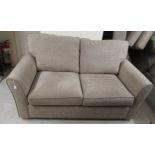 A modern two seater settee with a level back,