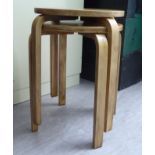 In the manner of Alvar Aalto Finmar Ltd, a pair of laminated stacking occasional tables,