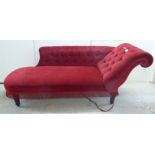 An early/mid 20thC chaise longue with a buttoned red upholstery and a later tasselled fringe,