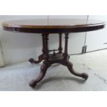 A late Victorian walnut breakfast table,