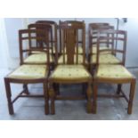 A matched set of nine early 20thC oak framed dining chairs,