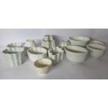 Twelve early 20thC and later ceramic jelly moulds of varying size and form: to include Booths and