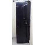 An LG 60/40 fridge/freezer with a built-in water dispenser 75''h 23.