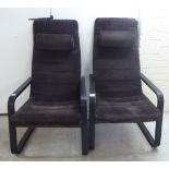 A pair of Ikea black painted wooden showwood framed open armchairs,