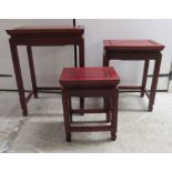 A nesting set of three modern Chinese mahogany occasional tables,