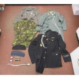 German military uniforms: to include a Third Reich SS tunic and greatcoat;