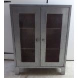 A modern industrially inspired ventilated cupboard with a pair of grille front doors,