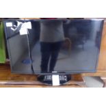 A Samsung 26'' flatscreen television with a remote control BSR