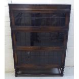 A mid 20thC Globe Wernicke style oak bookcase with three glazed, rise-and-slide doors,