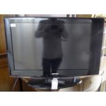 A Samsung 30'' television with a remote control U