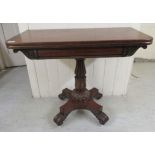 An early/mid 19thC mahogany tea table, the rotating, foldover top with round corners,