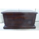 A 20thC Georgian design mahogany finished chest with a hinged lid and opposing brass bail handles,