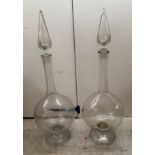 A pair of 'oversized' blown glass decanters and stoppers 42''h BSR