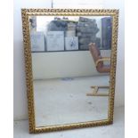 A modern mirror, the plate set in an antique inspired,