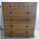 A modern pine dressing chest with two short/four long drawers,