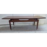 A mid 1970s teak coffee table, the top with rounded end,