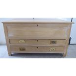 A modern light oak chest with straight sides and a hinged lid, over two long drawers,