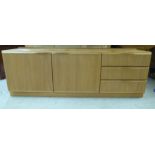 A McIntosh teak sideboard with two doors and a bank of three offset drawers, on a plinth 24''h 70.