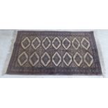 A Bokhara rug, decorated with two columns of seven octagonal guls,