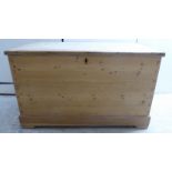 An early 20thC pine chest with straight sides and a hinged lid,