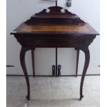 A ladies mid 20thC mahogany writing desk, the top set with a tooled and gilded orange hide scriber,