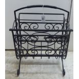 A modern black painted metal, two division magazine rack,