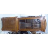 A modern burr walnut and mahogany finished corner cabinet with a glazed door, over a panelled door,