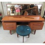 A G-Plan teak five drawer dressing table, surmounted by a mirror,