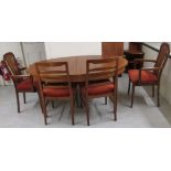 A modern teak dining table, the oval top raised on square,