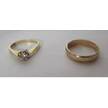 An 18ct gold wedding band;