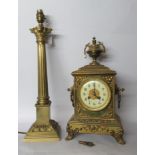 A 20thC lacquered brass cased mantel clock, the movement faced by an Arabic dial, raised on cast,