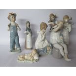 Seven Lladro porcelain figures: to include a young boy wearing dungarees 8''h U