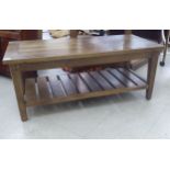 A modern hardwood two tier coffee table, raised on square,