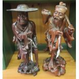 Two similar early 20thC Oriental carved hardwood, standing figures,