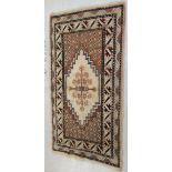 An Indian woollen rug, decorated with stylised designs,