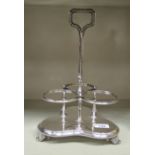 A Victorian silver plated bead bordered table tantalus with a central handle and three conjoined