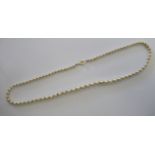 A graduated pearl necklace with yellow metal spacers,