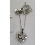 An 18ct white gold and diamond set open heart pendant,