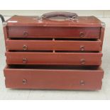 A 1930s stained mahogany collector's four drawer cabinet with a lockable fall front and carrying