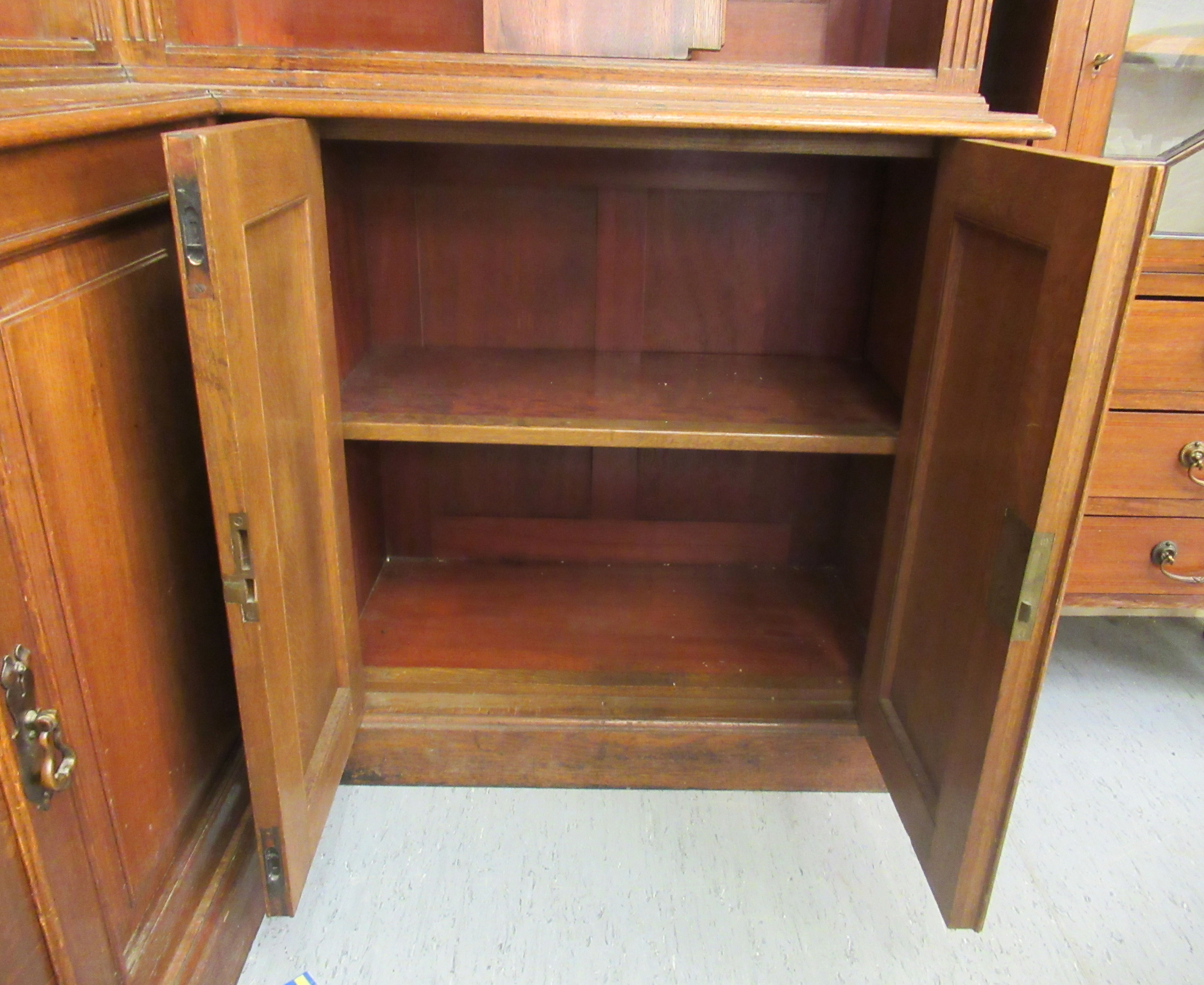 An Edwardian oak L-shaped library bookcase, having a moulded cornice, - Image 5 of 5