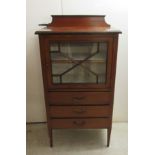 An Edwardian string inlaid mahogany music cabinet with a glazed door,