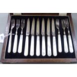 A set of six silver fruit knives and forks on mother-of-pearl handles Sheffield 1935 cased