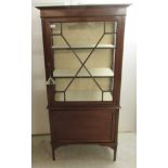 An Edwardian string inlaid mahogany two part display cabinet, the top with a glazed door,