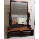 A Regency mahogany framed toilet mirror, the rectangular plate set between pivoting horns,