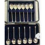 Two sets of six silver coffee spoons,